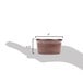 A hand holding a Tuxton Artisan Red Rock ramekin filled with brown liquid.