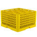 A yellow plastic Vollrath Traex rack with 12 compartments.