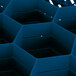 A Vollrath Traex royal blue glass rack with blue hexagon-shaped compartments.