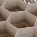 A beige plastic Vollrath Traex glass rack with 12 compartments.