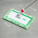 An Unger aluminum pad holder attached to a green mop.