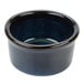 A blue ceramic Tuxton ramekin with a black rim.