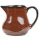 A brown pitcher with a handle on a white background.