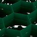 A green plastic Vollrath Traex glass rack with 12 compartments shaped like a hexagon.