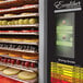 A Excalibur stainless steel food dehydrator filled with sliced apples.
