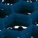 A blue Vollrath Traex glass rack with hexagons.