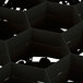 A black Vollrath Traex glass rack with hexagon compartments.