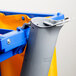 A grey plastic Unger toilet brush and swab holder with a blue handle.