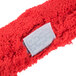 A red fuzzy strip washer with a white label.