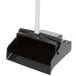 A black Unger angled lobby broom with a white handle.