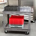 A Lakeside plastic utility cart with plastic containers and glasses on it.