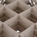 A Vollrath beige plastic glass rack with square compartments.