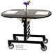 A Geneva Victorian cherry room service table with a vase of flowers on it.