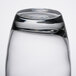 An Arcoroc Salto cooler glass filled with water on a table.