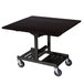 A Geneva rectangular room service table with an ebony wood finish and wheels.