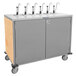 A stainless steel Lakeside serving cart with six metal pumps.