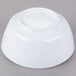 A white Thunder Group melamine bowl on a gray surface.