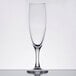 An Arcoroc champagne flute with a stem and black rim.