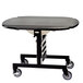 A black Geneva tri-fold room service table with wheels.