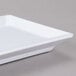 A close-up of a white rectangular Thunder Group melamine plate.