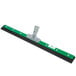 A green and black Unger AquaDozer floor squeegee with a metal handle.