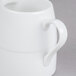 A white Arcoroc Rondo creamer with a handle.