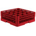 A red Vollrath plastic glass rack with 16 compartments.