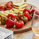 A plate of food with whole cherry peppers on a table.