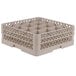 A beige plastic Vollrath glass rack with 16 compartments.