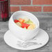 A bowl of fruit in a white 10 Strawberry Street Whittier angled bowl.