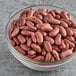 A bowl of dried light red kidney beans.