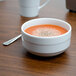 An Arcoroc Rondo cereal bowl filled with grapefruit sits on a table.