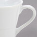 A close-up of a white Arcoroc coffee cup with a handle.