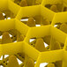 A close up of a Vollrath yellow plastic glass rack with open rack extender on top.