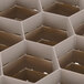 A white plastic grid with hexagonal compartments.