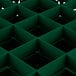 A green plastic grid with square compartments and holes.