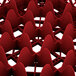 A close-up of a red Vollrath Traex glass rack with 25 compartments.