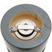 A close-up of a circular green and gray metal Chef Specialties pepper mill.