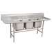 A stainless steel Advance Tabco three compartment sink with two drainboards.