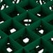 A green plastic Vollrath Traex glass rack with many compartments.