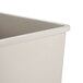 A close-up of a beige Rubbermaid rigid plastic liner.