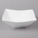 A white square bowl on a gray surface.