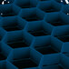 A blue Vollrath Traex glass rack with black compartments.
