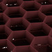 A red Vollrath Traex glass rack with hexagonal compartments.