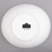 A white porcelain bowl with cut outs.