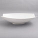 A close up of a white 10 Strawberry Street Whittier rectangular samurai bowl with curved edges.