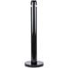 A black cylindrical Rubbermaid cigarette receptacle with a black cap.