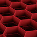 A red Vollrath Traex rack with hexagonal compartments.