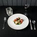 A plate of food on a table with a fork and knife.