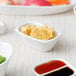 A table with a variety of food in 10 Strawberry Street white rectangular bowls.